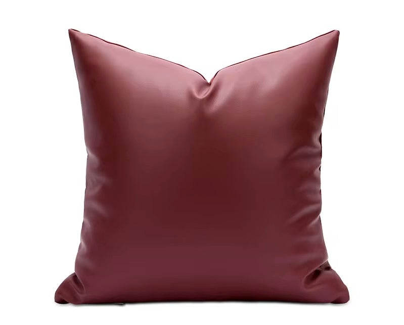 Detailed view of the hidden zipper closure tucked into the seam of the red pillow.