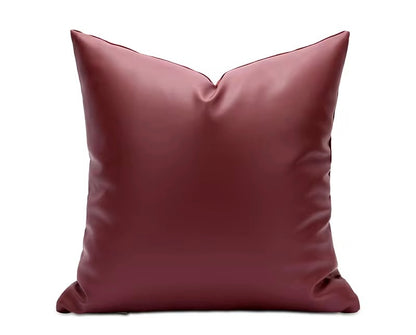 Detailed view of the hidden zipper closure tucked into the seam of the red pillow.