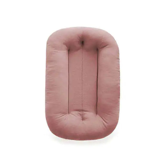 Pink lightweight bionic baby bed with side handles for easy travel and transport.