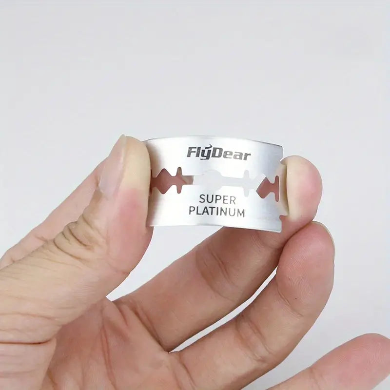 Close up of a single platinum coated double edge razor blade showing the sharp beveled edge.